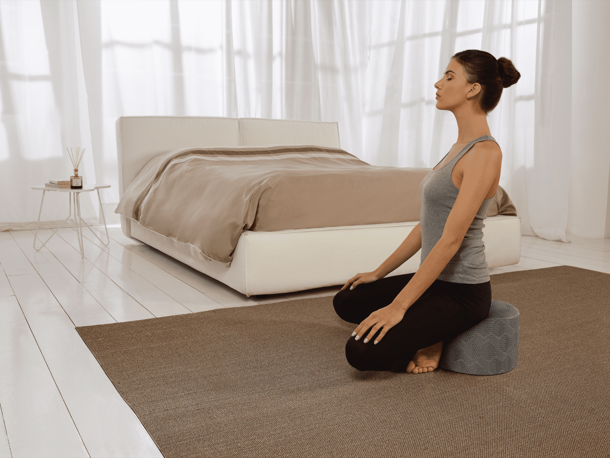 A person meditating in a serene room with a Magniflex mattress, enhancing relaxation and supporting a healthy circadian rhythm.