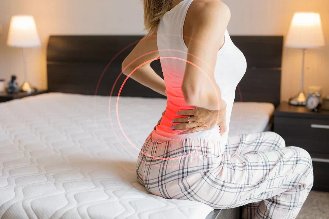 Woman experiencing back pain because of her mattress.