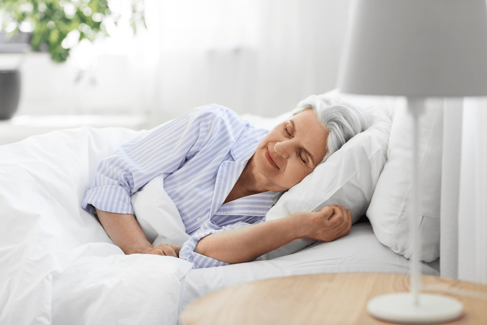 An old woman peacefully sleeping on a Magniflex medical mattress Dubai showcases top-quality design and innovative features.